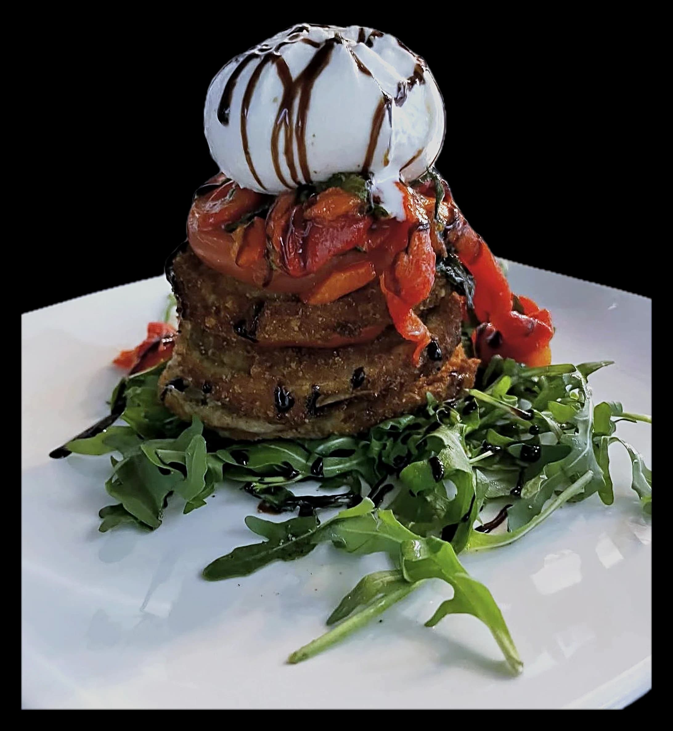 Burrata Della Nonna — fresh burrata over crispy eggplant with roasted red peppers and balsamic