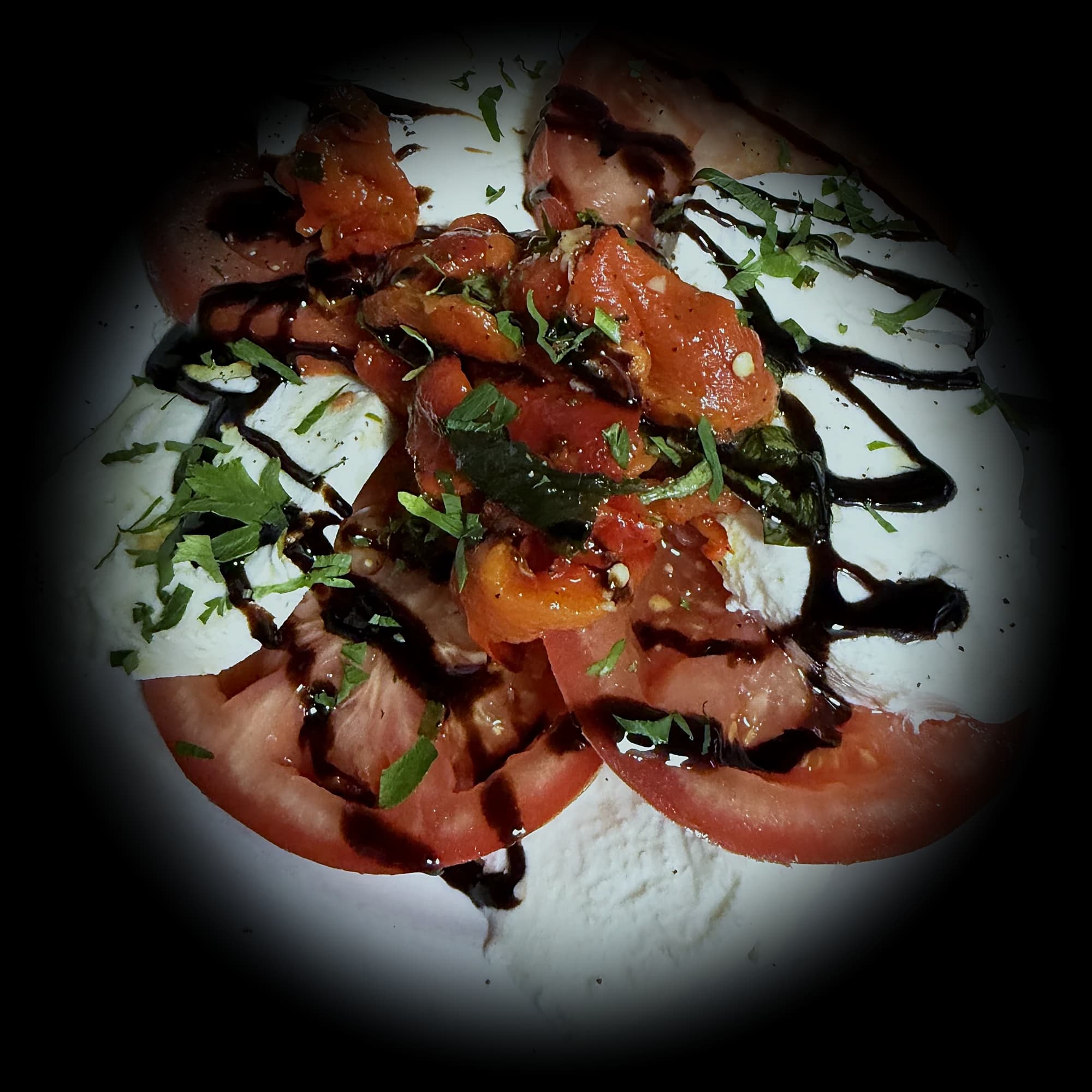 Caprese salad — sliced tomato, fresh mozzarella, basil and balsamic glaze