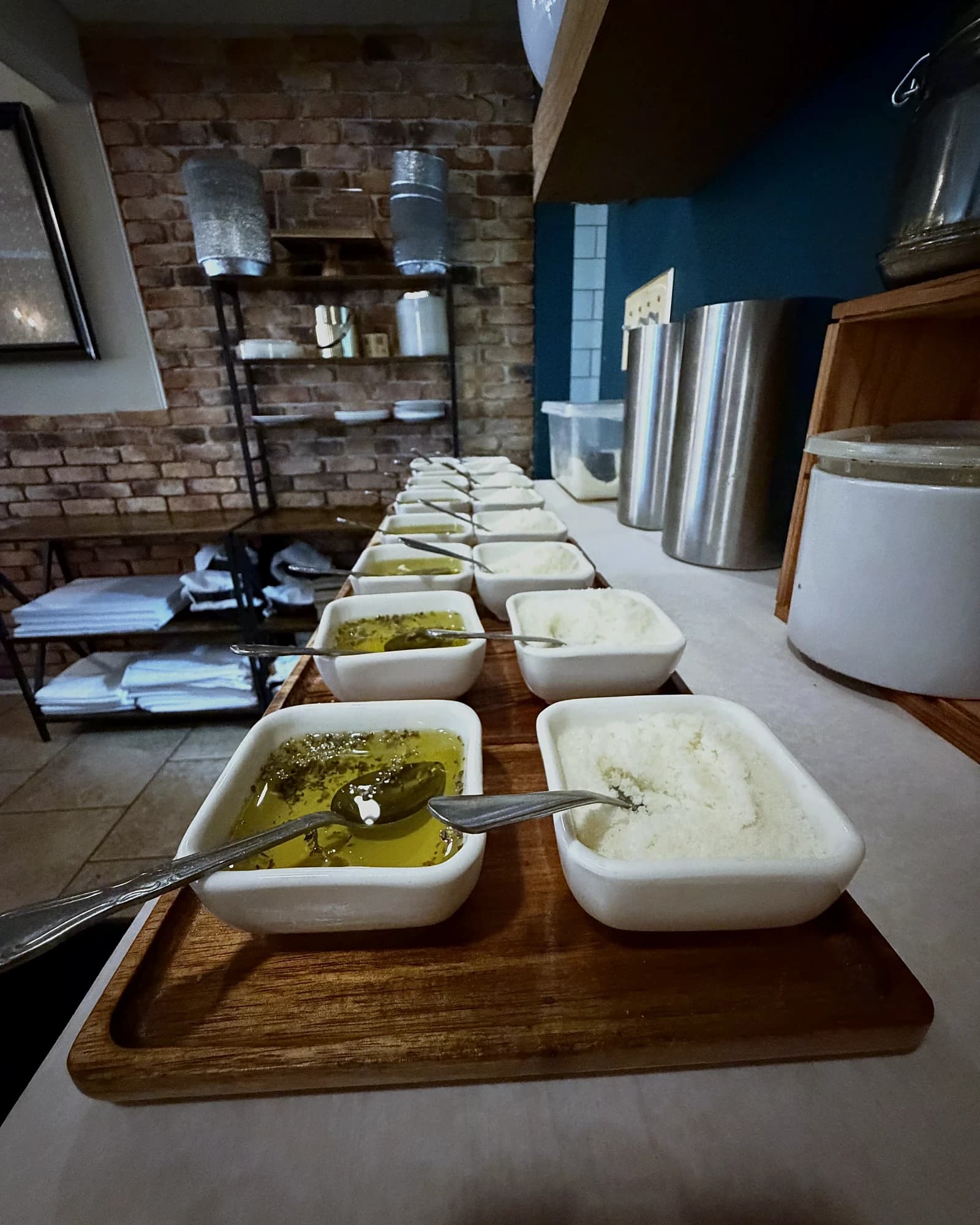 Bread service — olive oil, herbs and grated cheese on a wooden board