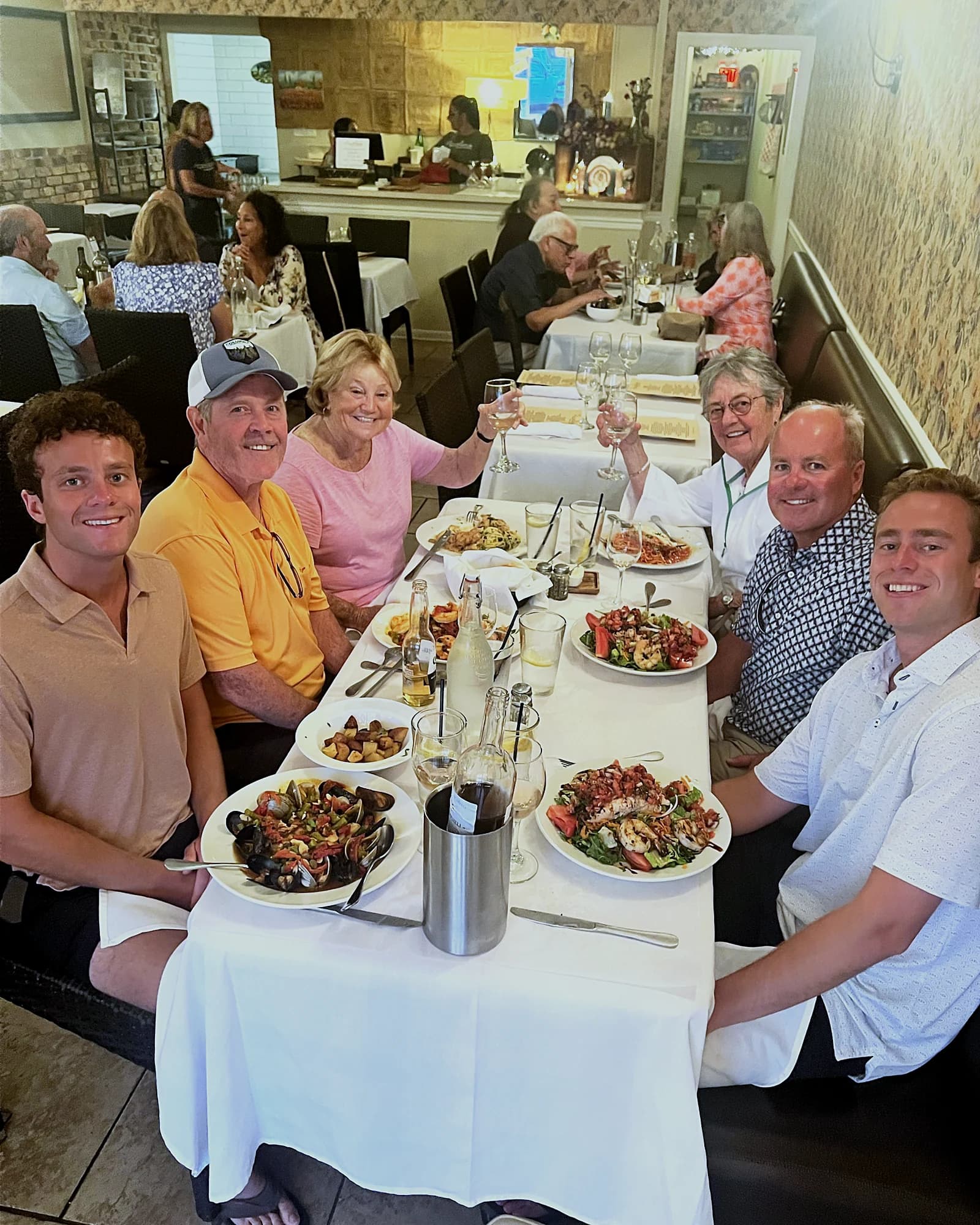Guests raising a glass around a long table at Piccolino