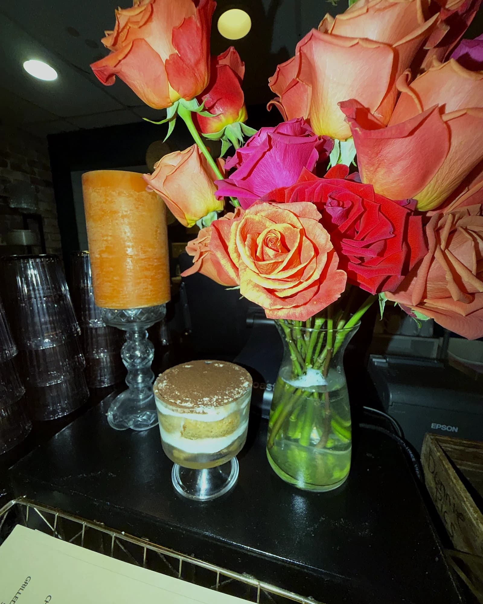 Tiramisu and fresh roses by the host stand