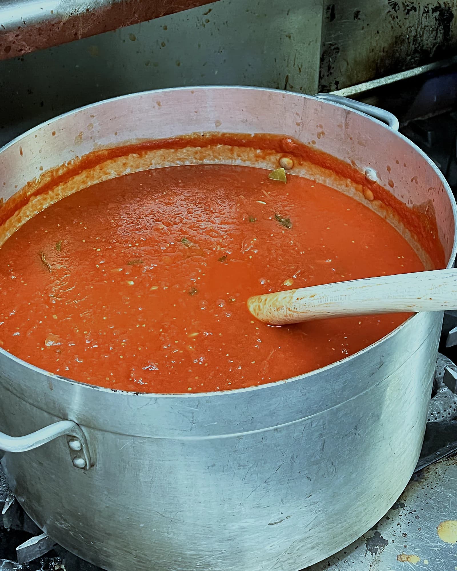 A full pot of tomato sauce simmering on the kitchen range