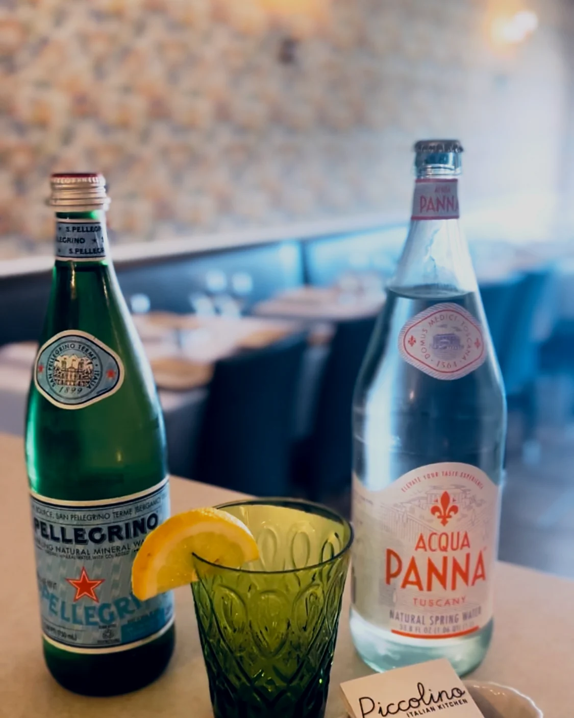 San Pellegrino and Acqua Panna on the table with a Piccolino card